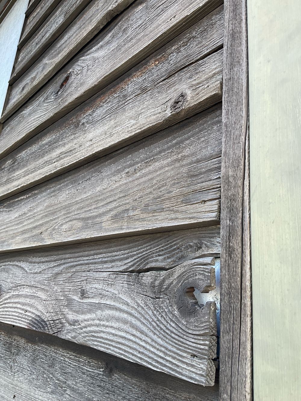 Damaged cladding that will deteriorate further in the weather, Newport, Mambourin