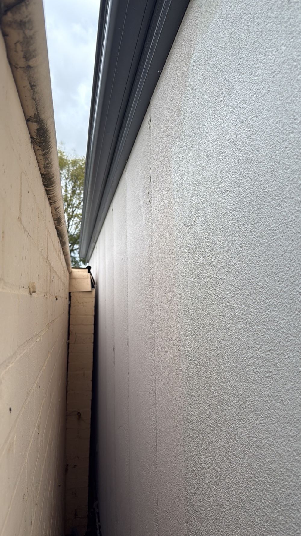 Boundary wall panels left uncoated and exposed to weather for years, Herne Hill, Mambourin