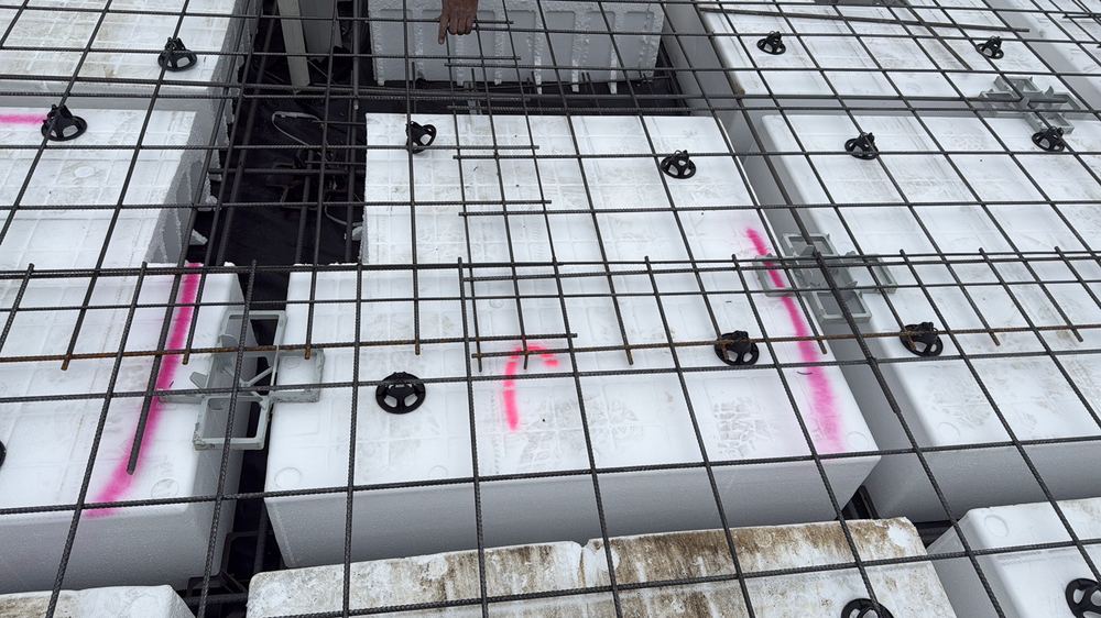 Steel sagging low in a beam trench, with additional bar chairs required, found during a slab pre-pour inspection in Mambourin