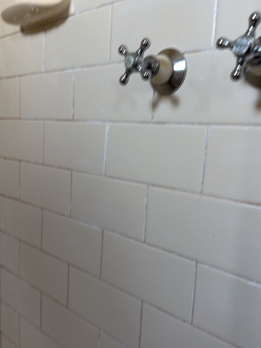 Degraded shower grout letting water work in behind the tiles, Newport, Mambourin